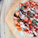An over head photo of bruschetta pizza with balsamic glaze.