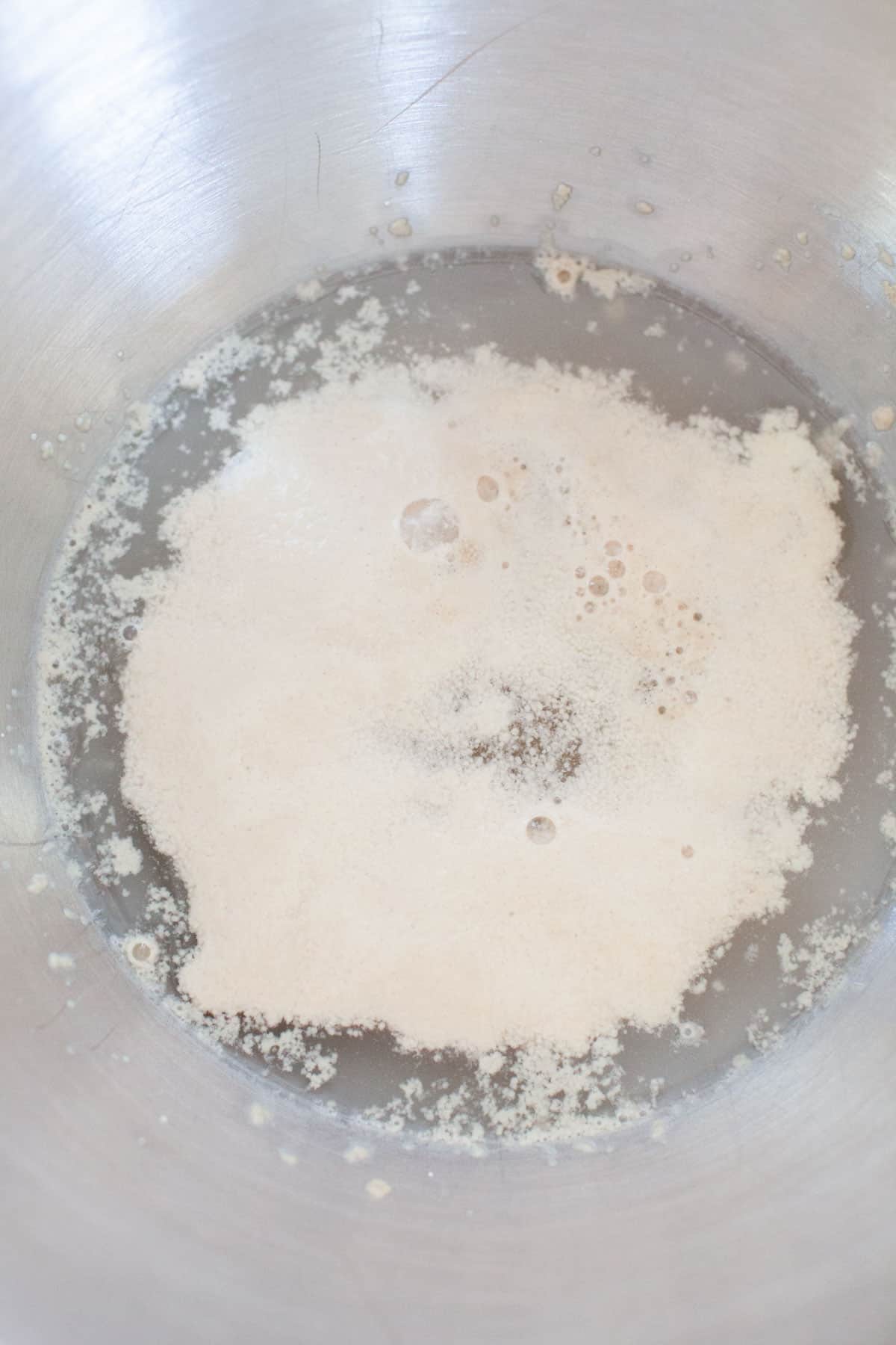 Activated yeast with water and mixing bowl.