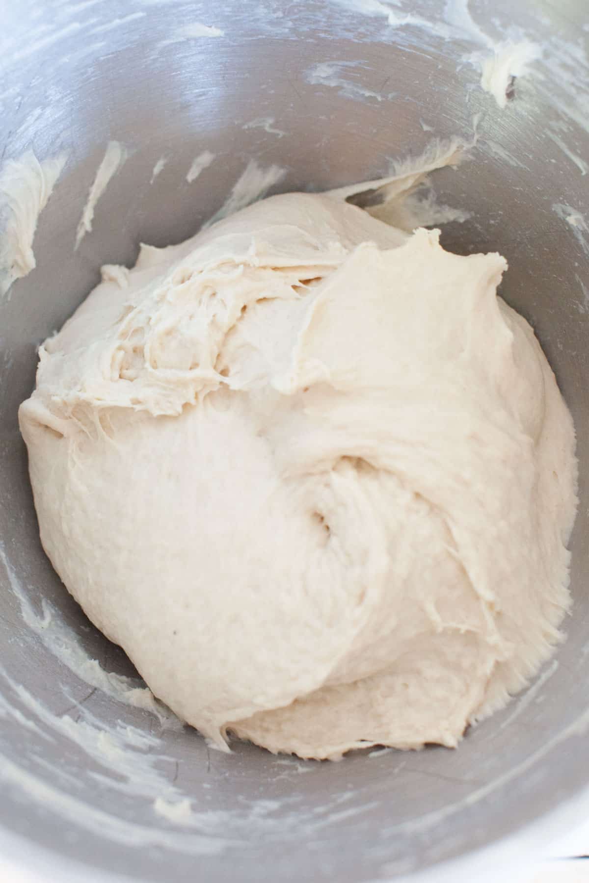 Flour and yeast combined to make dough in mixing bowl.