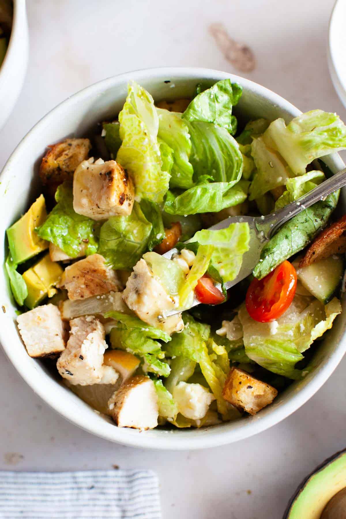 Close up photo of grilled chicken salad mixed together with the honey vinaigrette.