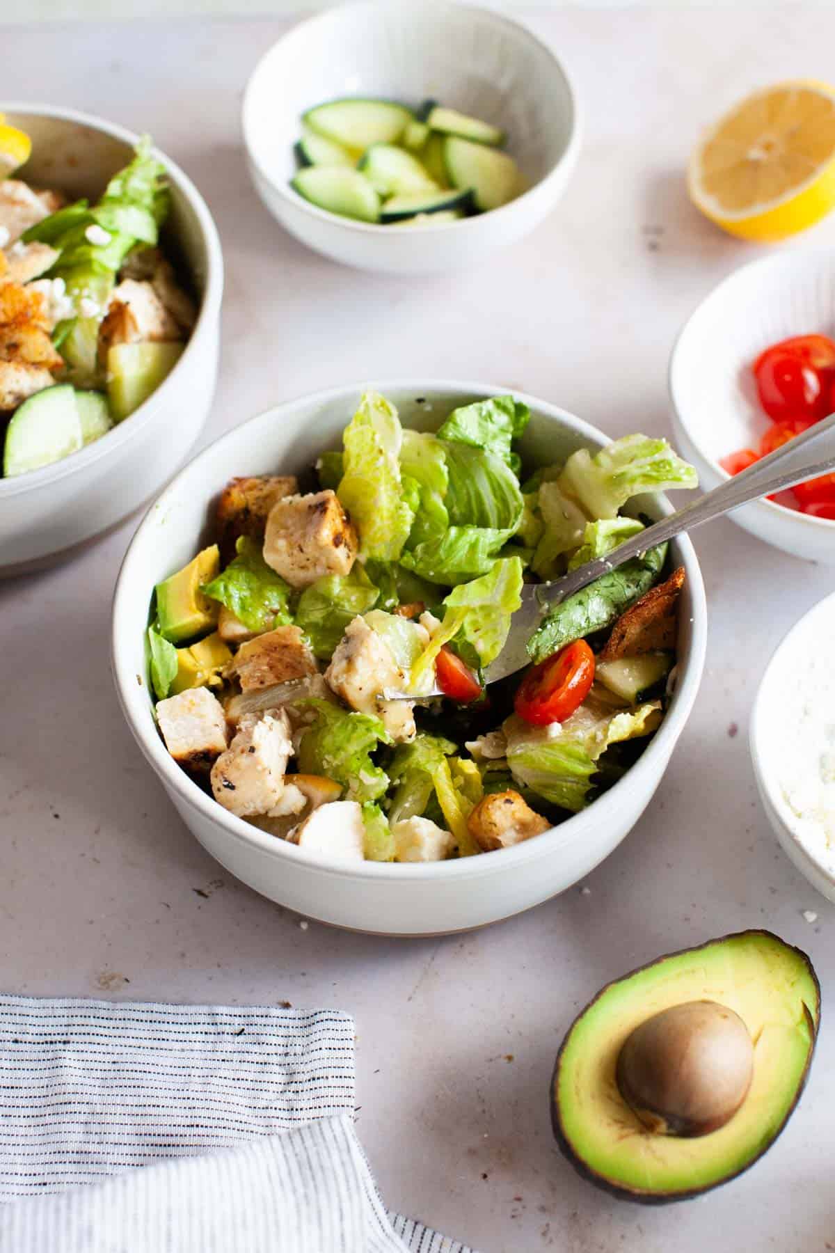 Close up photo of grilled chicken salad mixed together with the honey vinaigrette.