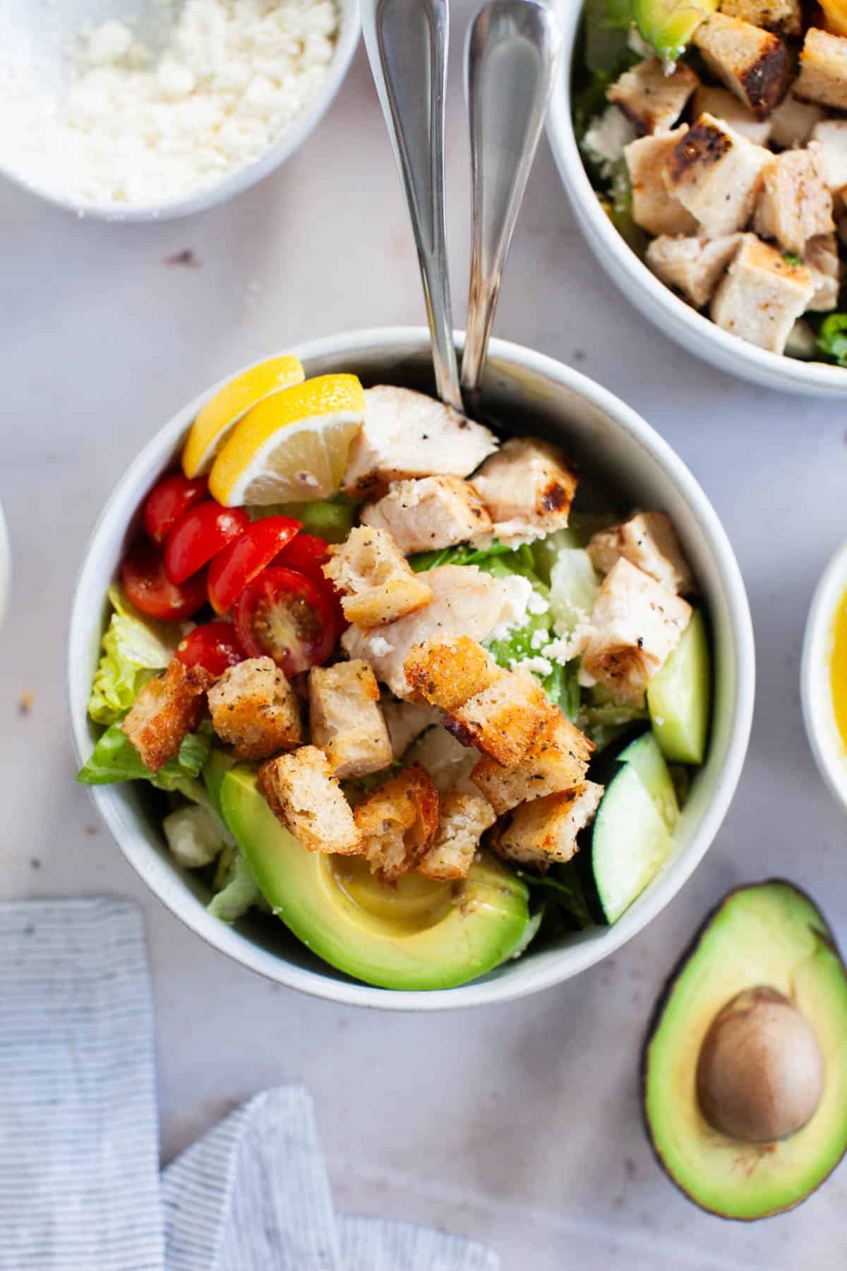 Grilled chicken salad with honey vinaigrette in a white bowl.