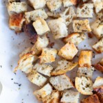 Homemade croutons on a baking sheet.