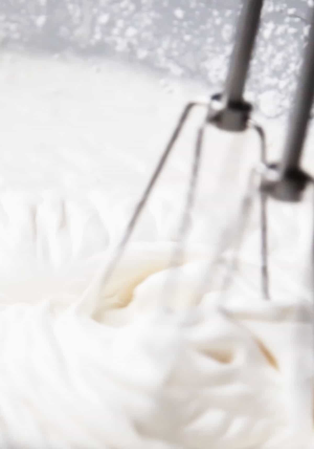 a mixer making whipped cream frosting.