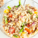 Greek quinoa salad in a glass bowl.