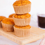 Three pumpkin muffins stacked on top of each other.