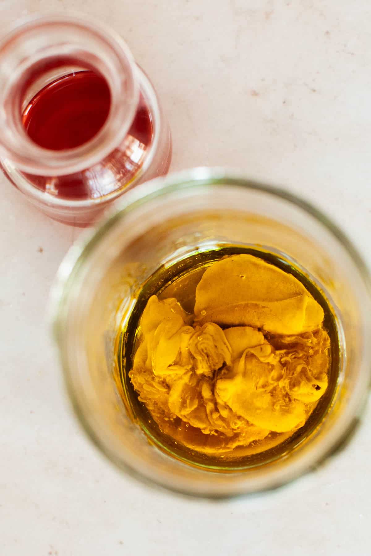 Dijon mustard and honey mixed into a mason jar.