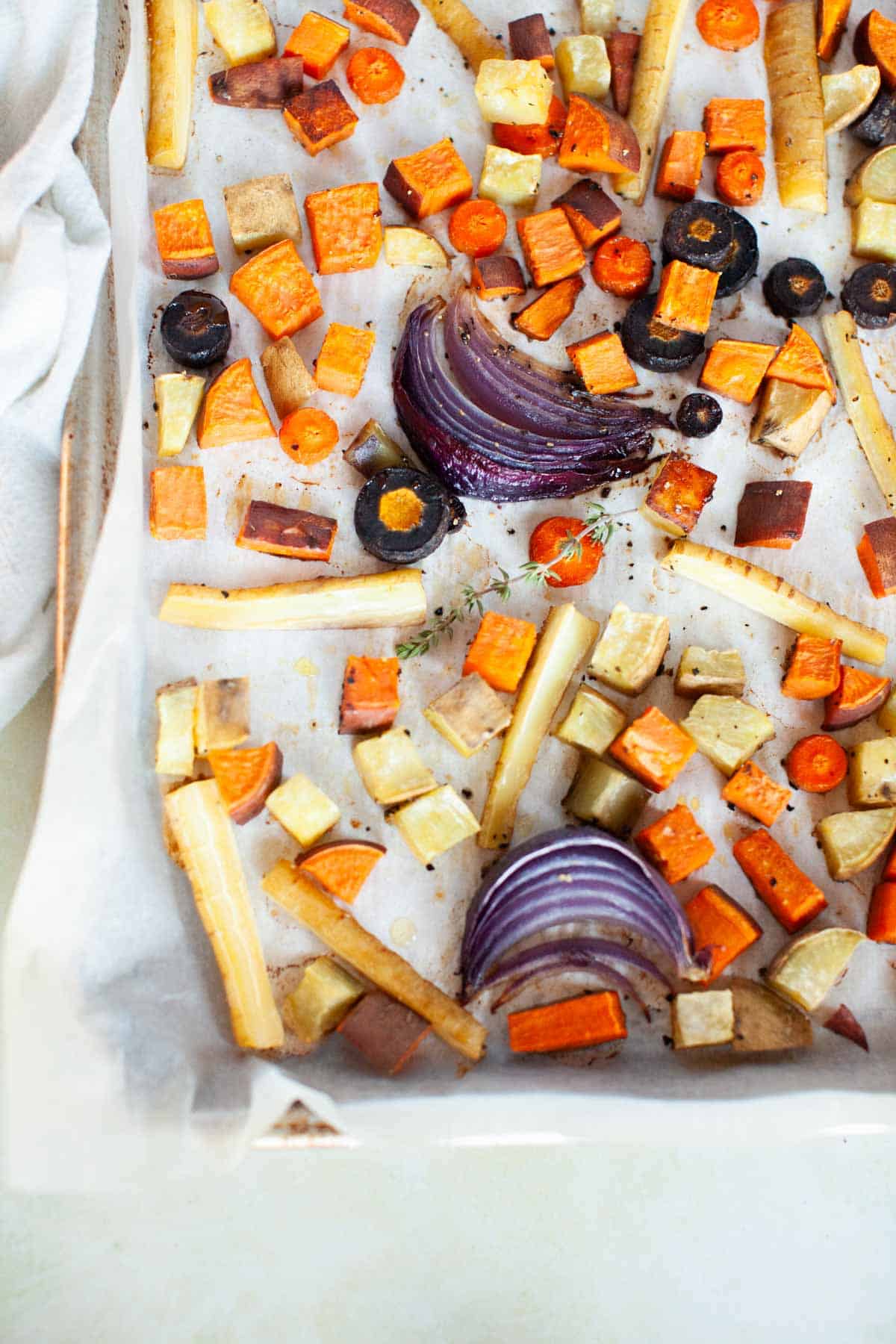 Roasted red onion wedges, carrots, sweet potatoes, and yams.