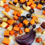 Roasted root vegetables on a baking sheet.