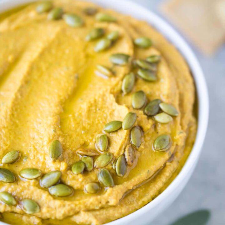 A platter of cheese, crackers and fruit.