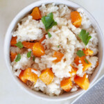 A bowl of butternut squash risotto with parsley.
