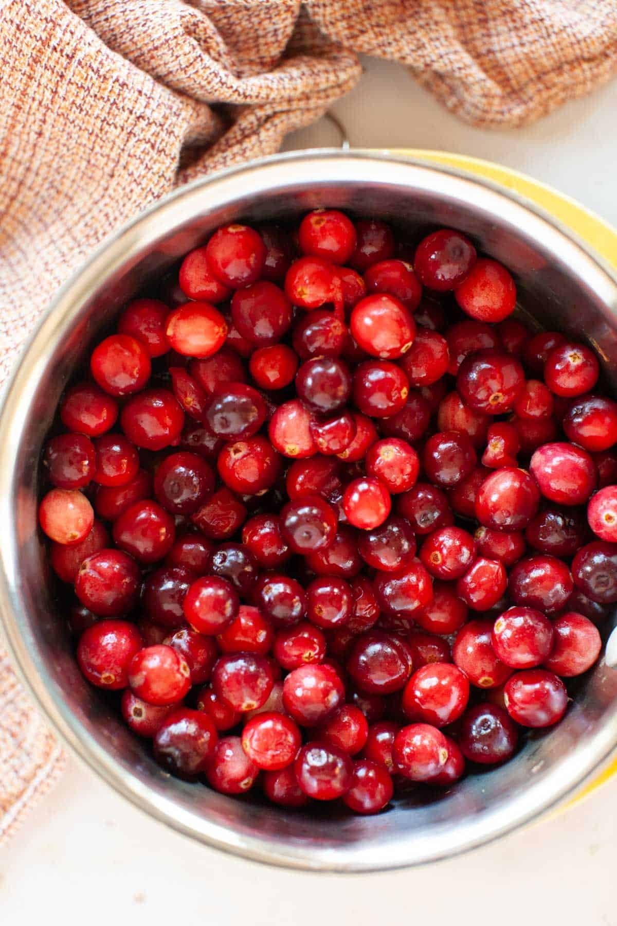 Cranberries in a stainless steel pot.