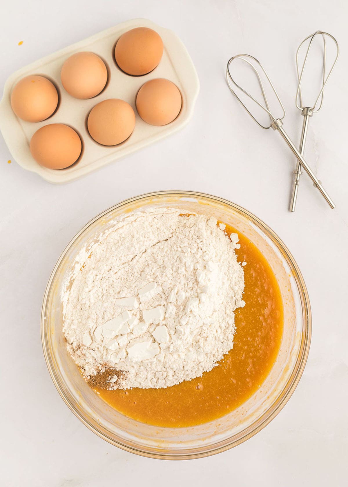 The flour, egg, and pumpkin cake spice mixture added to the eggs and canned pumpkin.