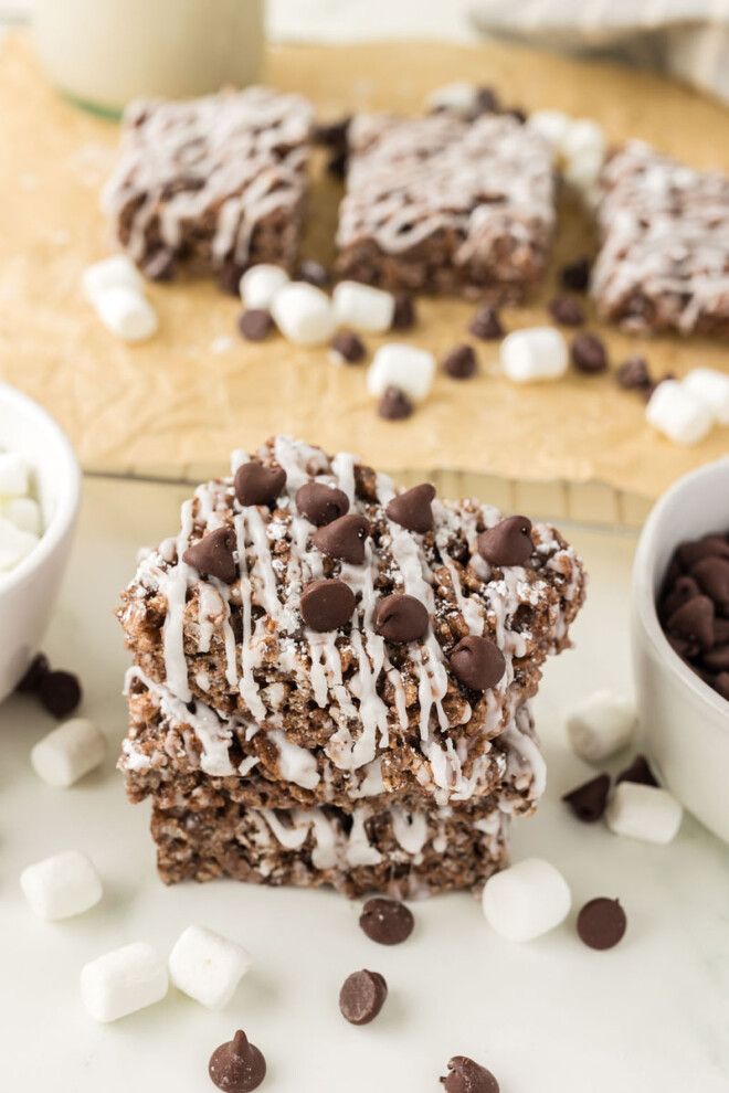 A stack of chocolate rice krispie treats topped with chocolate chips.