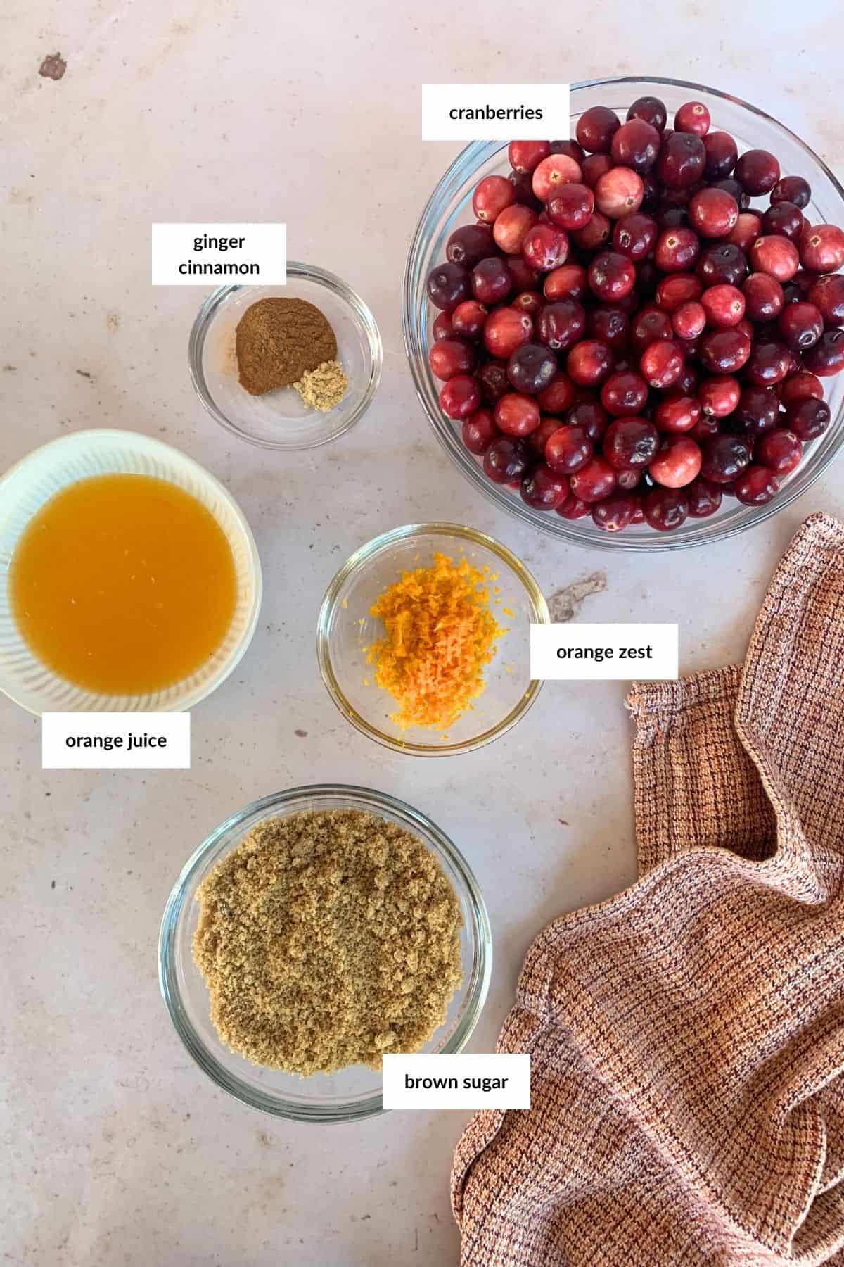 Ingredients for cranberry sauce in glass bowls.