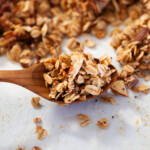 A wooden spoon with healthy granola on it.