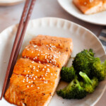 Teriyaki-glazed salmon with broccoli on a plate.