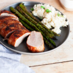 Dry rub pork tenderloin slices, risotto and asparagus on it.