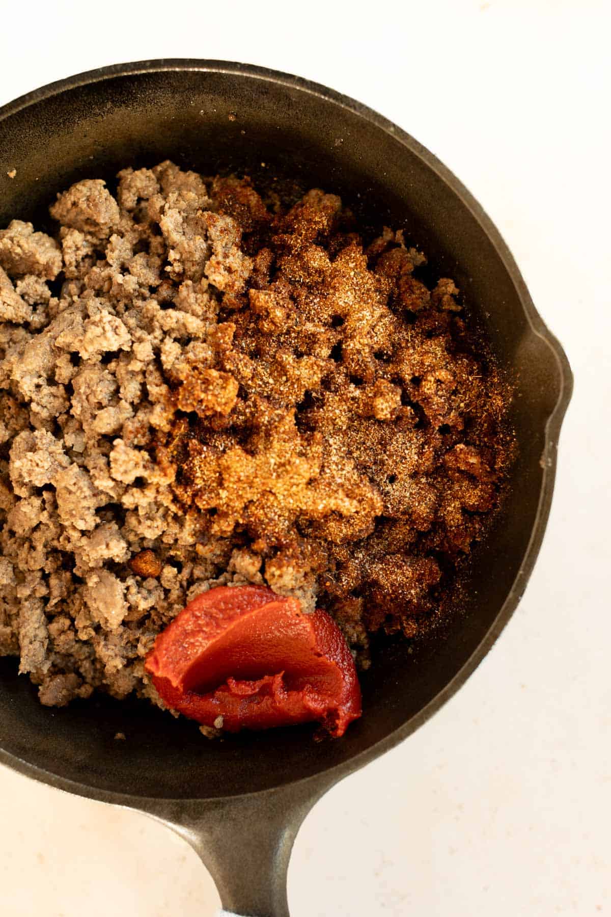 A bowl of ground meat and tomato sauce.