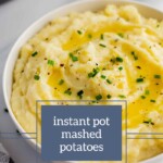 A bowl of creamy mashed potatoes garnished with chives and served with fruit salad dressings, labeled "instant pot mashed potatoes" from joyfullymad.com.