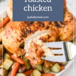 A fork holding a piece of seasoned chicken above a dish of oven roasted chicken with potatoes and carrots. The text overlay reads, "oven roasted chicken" and "joyfullymad.com.