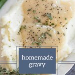 Mashed potatoes with homemade gravy, garnished with herbs, rest on a plate where green beans and a touch of apple pancakes add a unique twist in the corner.