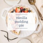 Top view of a delightful pudding pie topped with strawberries and blueberries, featuring two inviting slices on small plates and a pie server nearby.