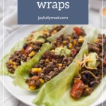 A plate of savory beef lettuce wraps filled with juicy corn, black beans, ripe tomatoes, and creamy avocado chunks.