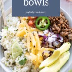 A bowl with seasoned ground beef, rice, shredded cheese, avocado slices, jalapeño, red onion, cilantro, and lime wedge. Or try a twist with baked chicken meatballs. Text overlay reads, "taco bowls joyfullymad.com".