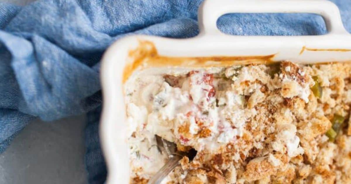 Jalapeno popper dip appetizer in a white baking dish, viewed from overhead.