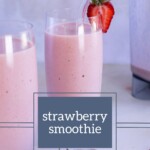 Two glasses of pink strawberry smoothie with glass straws and a strawberry garnish sit beside fresh strawberries and a blender. The text overlay reads "strawberry smoothie.