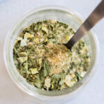 A spoon in a jar of ranch seasoning.