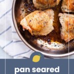 A stainless steel skillet with three pan-seared chicken thighs, seasoned and browned, sits on a striped cloth. Text overlay reads: "pan seared chicken thighs.
