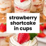 Small glass jars filled with strawberry shortcake layers, whipped cream, and topped with a fresh strawberry. Text overlay reads “strawberry shortcake in cups.”.
