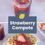A jar of strawberry compote and a plate of waffles topped with the compote and fresh strawberries are shown on a light table.