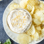 A bowl of creamy dip topped with seasoning.